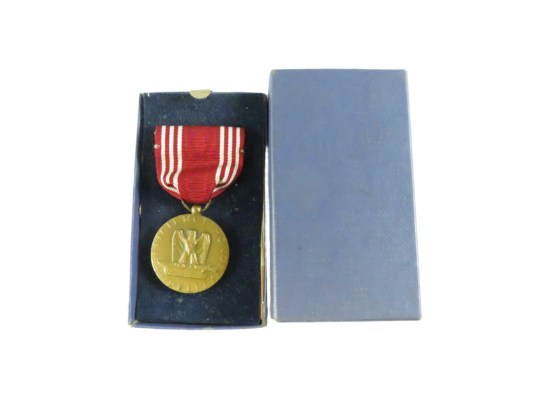 WW2 good conduct medal with red ribbon in a blue box on a white background