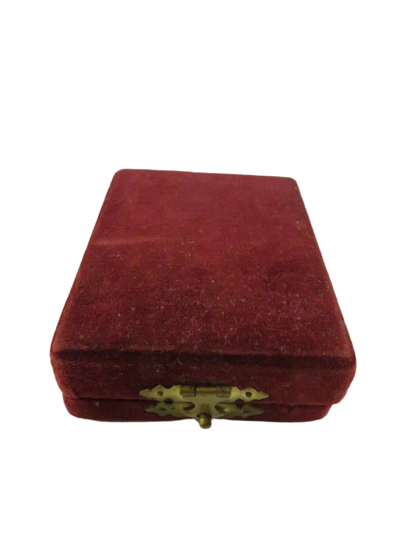 Red velvet jewelry box with a gold clasp on a white background