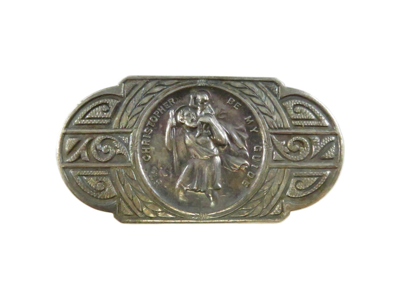 Decorative metal belt buckle with intricate designs on a white background