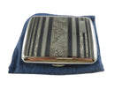Silver cigarette case with striped design on a blue cloth background