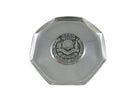 Silver octagonal object with a central emblem on a white background