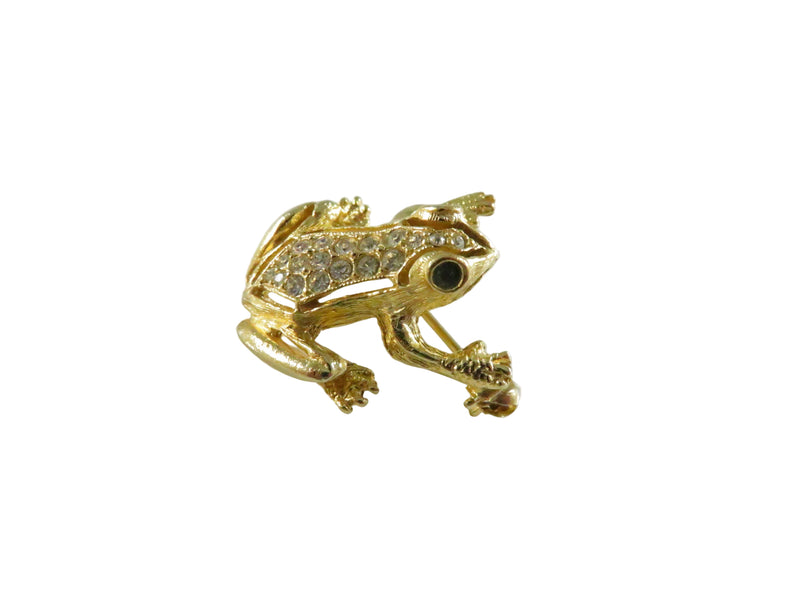 Gold frog-shaped brooch on a white background