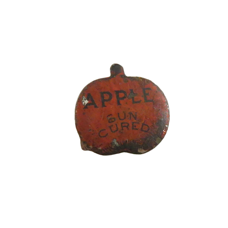 Small red apple-shaped object with 'Apple Gun Cured' text on a white background