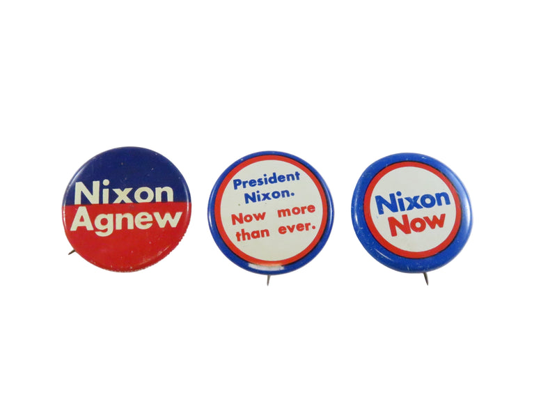 Three Nixon campaign buttons on a white background