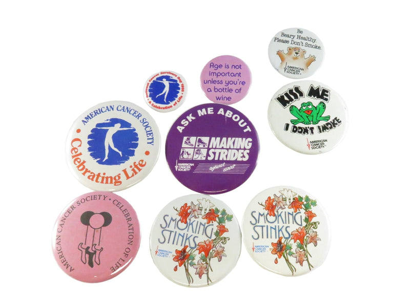 Collection of buttons with various designs and messages on a white background