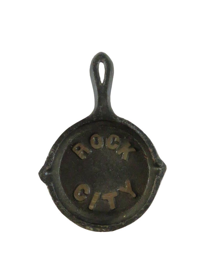 Small cast iron skillet with 'Rock City' engraving on a white background