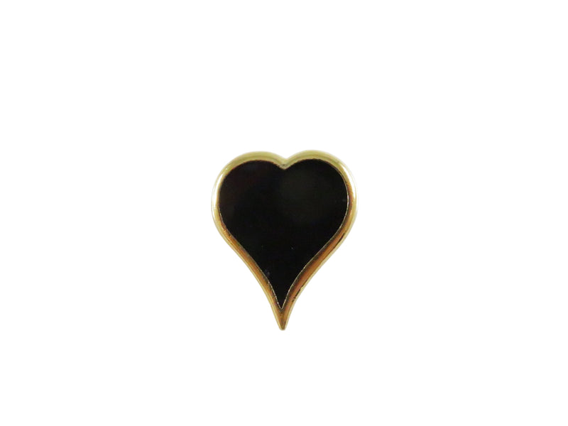 Heart-shaped object with black center and gold rim on a white background