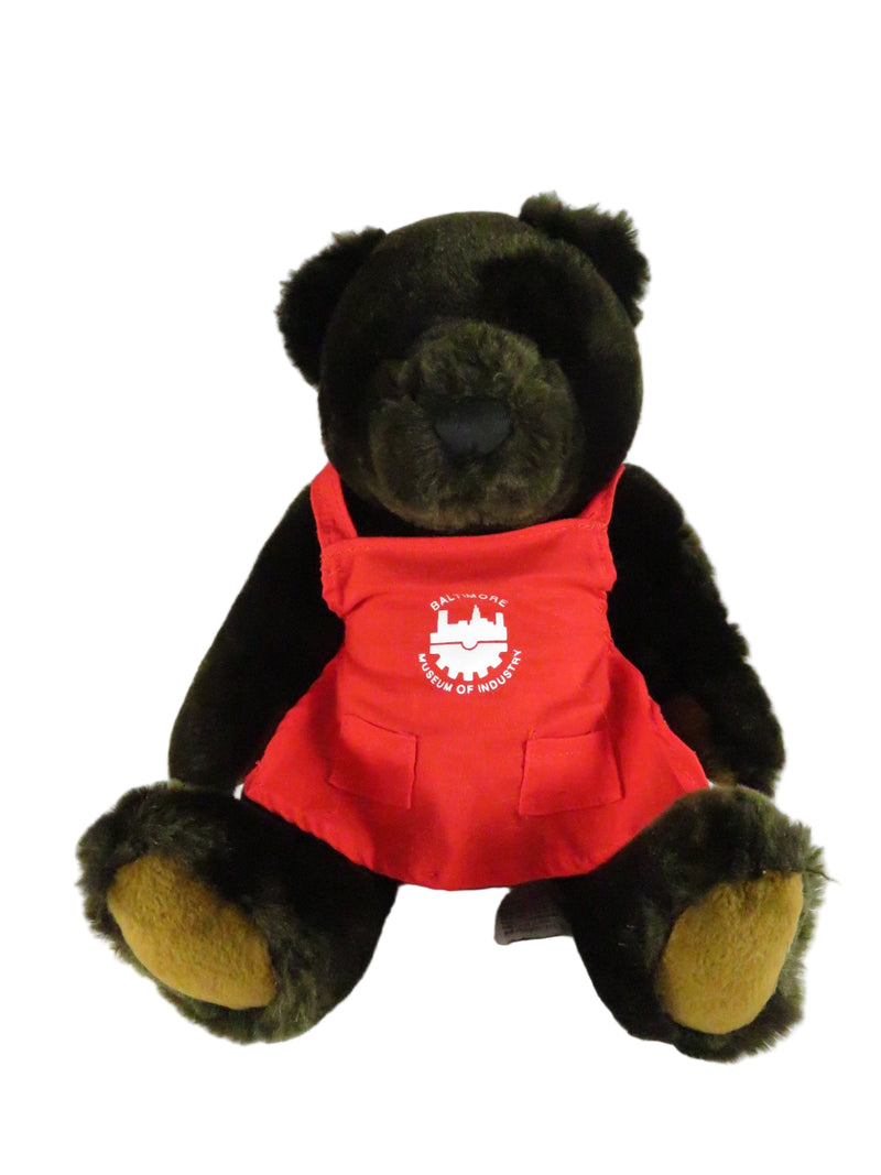 Plush bear toy wearing a red shirt with a logo on a white background