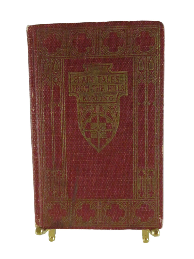 Red book with gold embossed design on a white background
