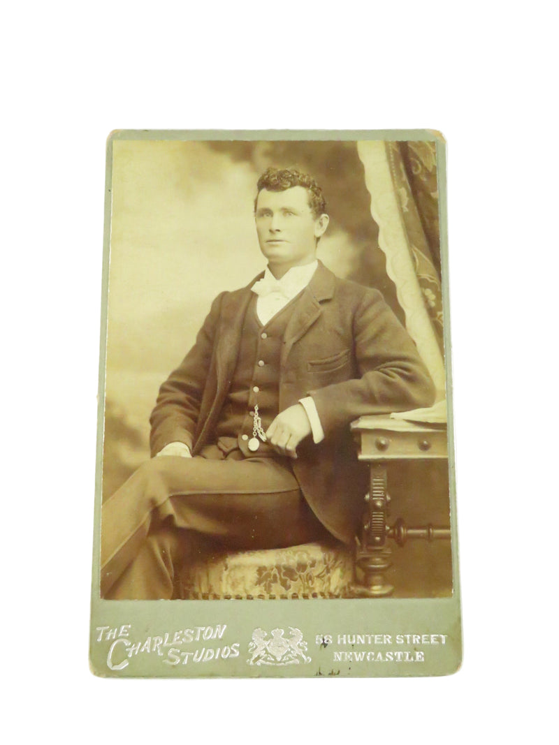 Vintage sepia-toned portrait of a man , featuring 'The Hawes Studio' branding.