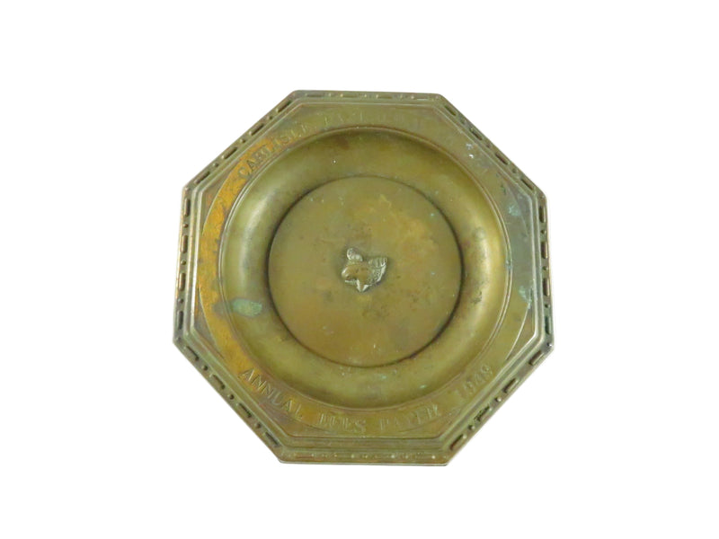 Decorative octagonal plate with central emblem on a white background