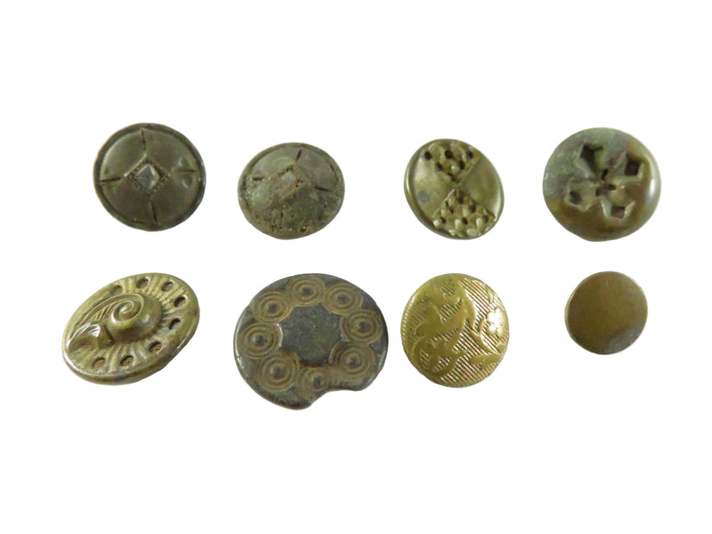 Collection of vintage buttons with different designs on a white background