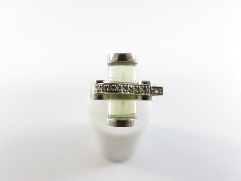 Silver ring with a green gemstone on a white background