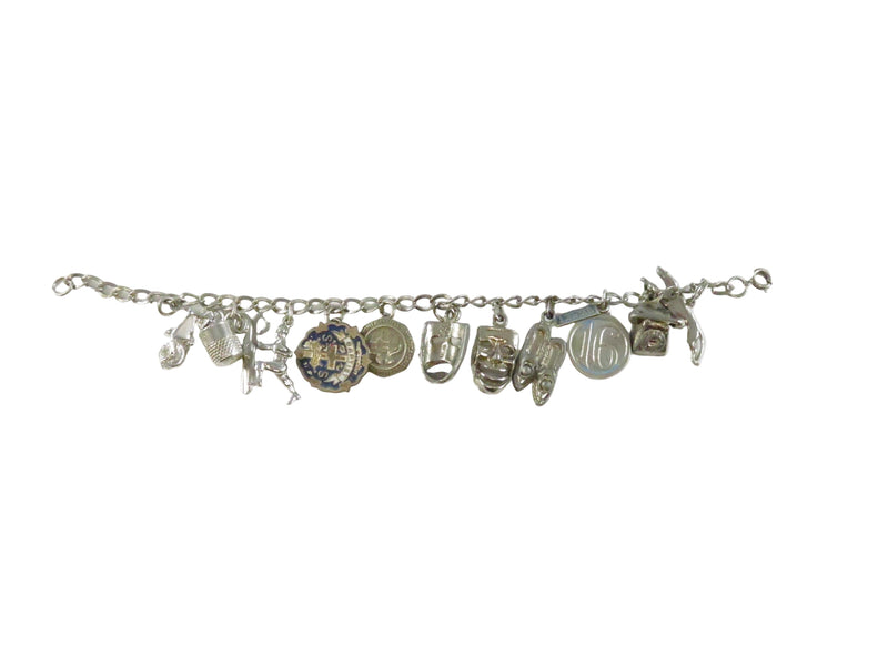 Silver charm bracelet with various charms on a white background