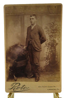 Man Leaning On Chair Antique Cabinet Card Rote Lancaster PA — front view