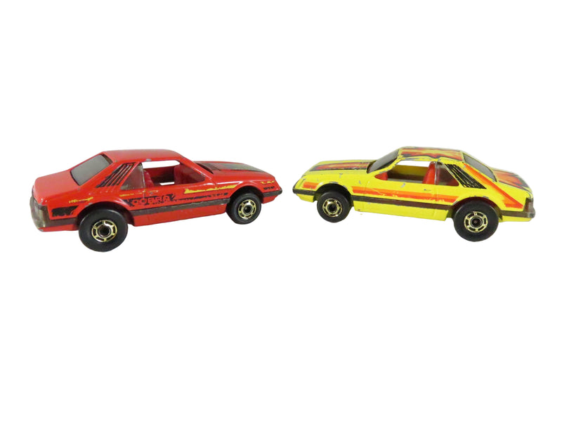 Two toy cars, one red and one yellow with black stripes, on a white background.
