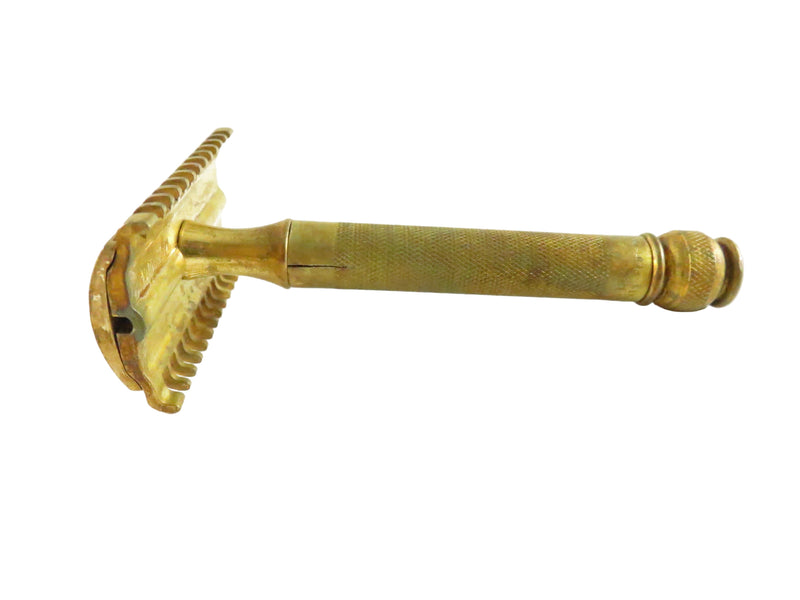 Brass safety razor on a white background