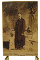 Man Long Trench Coat Stone Bench Antique Cabinet Card Frank W Cale Reading PA — front view