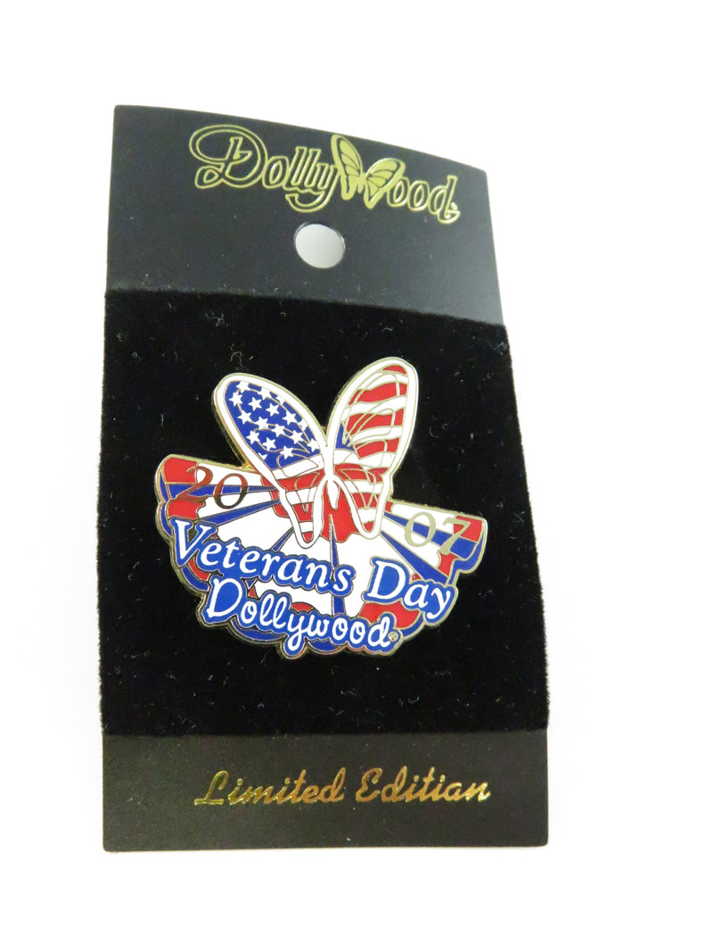 Veterans Day butterfly pin on a black card with 'Dollywood' branding
