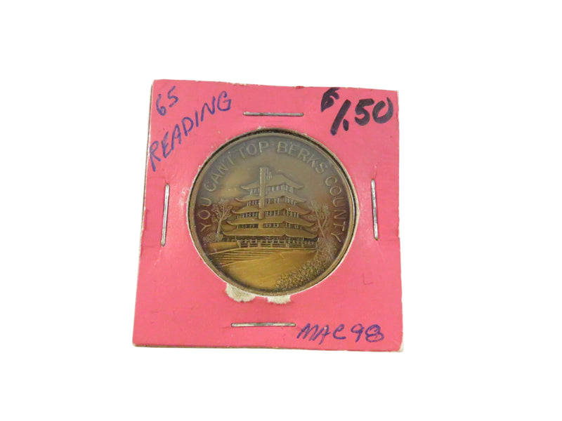 Gold coin in a pink holder with text on a white background