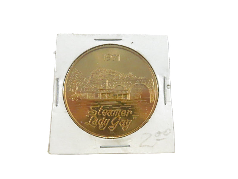 Gold coin with 'Steamer Lady Gay' engraving on a white background