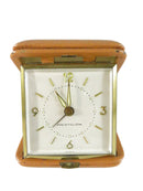 Vintage clock with brown leather case on a white background
