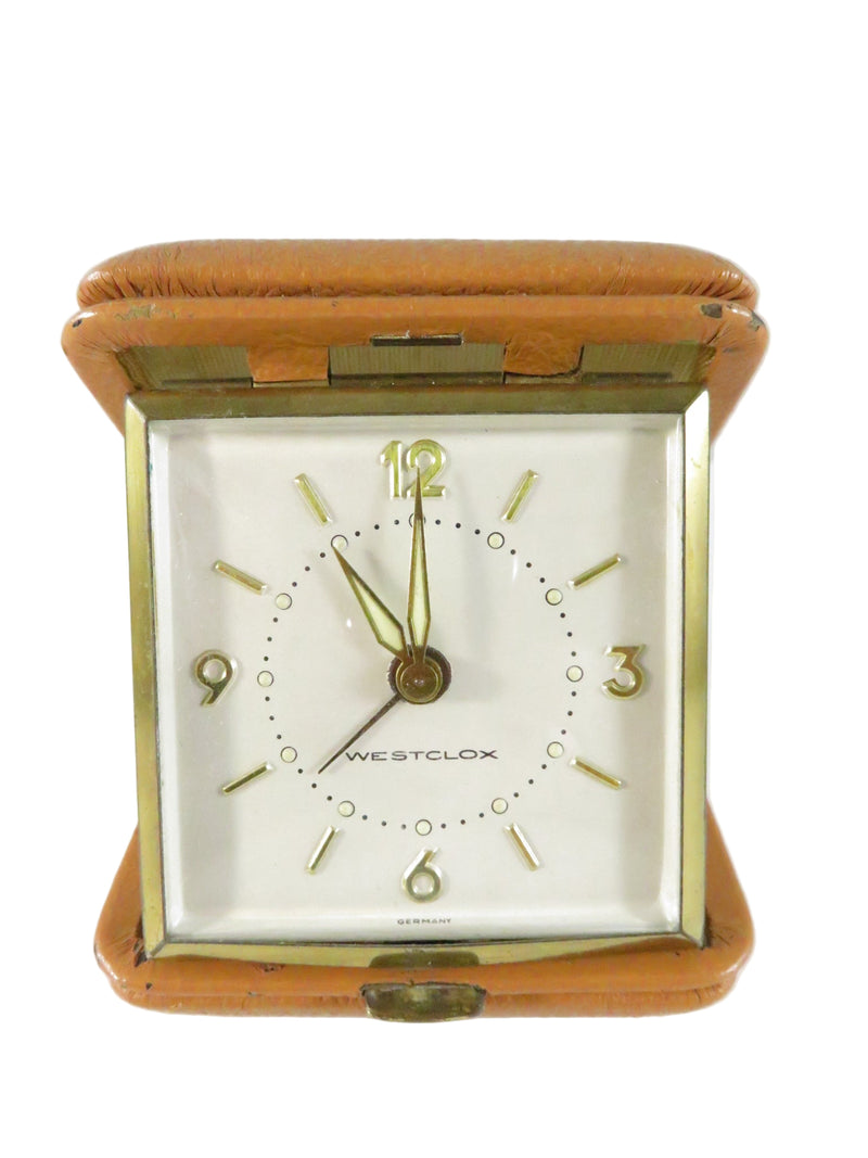 Vintage clock with brown leather case on a white background