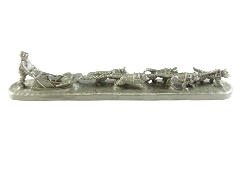 Decorative ceramic dog sled with dogs on a white background
