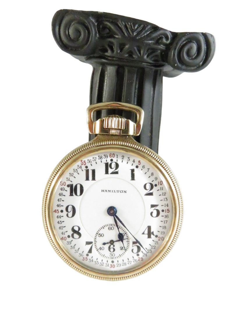 Hamilton pocket watch with decorative case on a white background