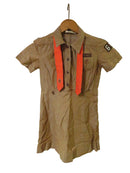 Brown dress with orange accents on a wooden surface