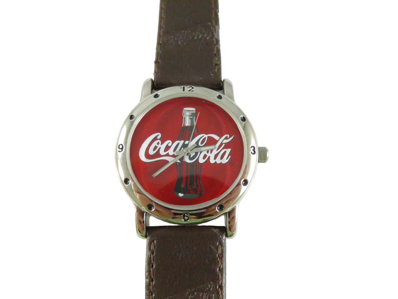 Coca-Cola watch with red face and brown leather strap on a white background