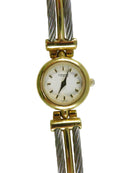 Gold and silver watch with a white face on a white background