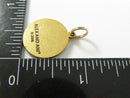 Angled back view of Alex and Ani 2016 brass charm and jump ring