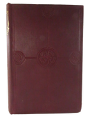 Front board of maroon cloth hardcover with blind-stamped floral and four-leaf-clover design.