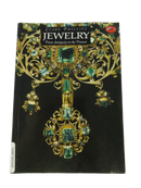 Front cover of Clare Phillips' Jewelry: From Antiquity to the Present, showing a gold and green gemstone bodice ornament.