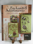 Front cover of Enchanted Adornments by Cynthia Thornton, subtitled Creating Mixed-Media Jewelry with Metal Clay, Wire, Resin & More, with photographs of jewelry pieces.