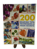 Front cover of 200 Beading Tips, Techniques & Trade Secrets by Jean Power, with photographs of beads and jewelry-making tools.
