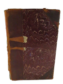 Close exterior view of Prince Otto showing marbled paper board, deteriorated leather corner pieces, and worn leather spine edge.
