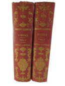Spines of the two red cloth volumes of Charlotte Elizabeth's Works, labeled Vol. 1 and Vol. 2, Dodd's Edition, with ornate gilt decoration.