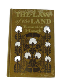 Front cover of The Law of the Land by Emerson Hough, in worn olive cloth with cotton-boll and revolver pictorial design.