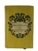 Front cover of David Harum by Edward Noyes Westcott in yellow cloth with an ornate black-and-red floral title design