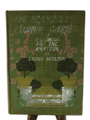 Front cover of The Shelton's Flower Card by Louise Shelton, green cloth with floral garden illustration and worn lettering