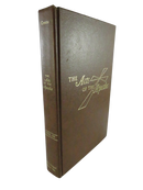 Front cover of The Acts of the Apostles, a brown leather hardcover with gilt title and cross-and-rays design.