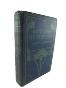 Decorated blue cloth front cover of Queenie Hetherton by Mary J. Holmes