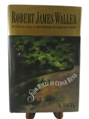 Front dust jacket of Slow Waltz in Cedar Bend by Robert James Waller, with gold author panel and wooded garden cover art.