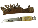 Whitetail Cutlery fixed-blade sawback hunting knife beside brown fringed suede leather sheath