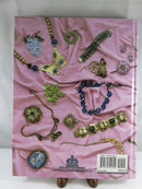 Back cover of the Collector Books hardcover, illustrated with assorted costume jewelry on pink fabric and showing ISBN 1-57432-182-X.