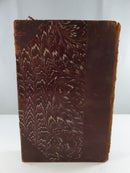 Rear cover of Prince Otto with dark marbled paper board and worn leather along the outer edge.