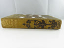 Spine of The Law of the Land showing faded gilt title lettering, floral decoration, and cloth wear.