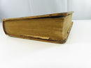 Fore-edge view showing toned, stained page edges and worn calf boards.